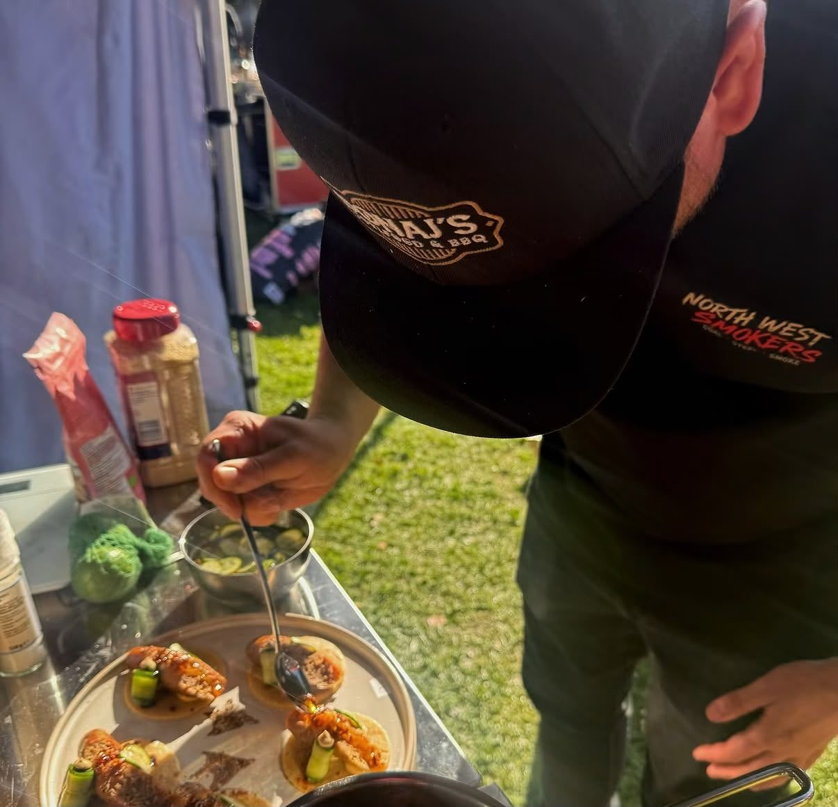 Finishing tacos with salsa at the festival
