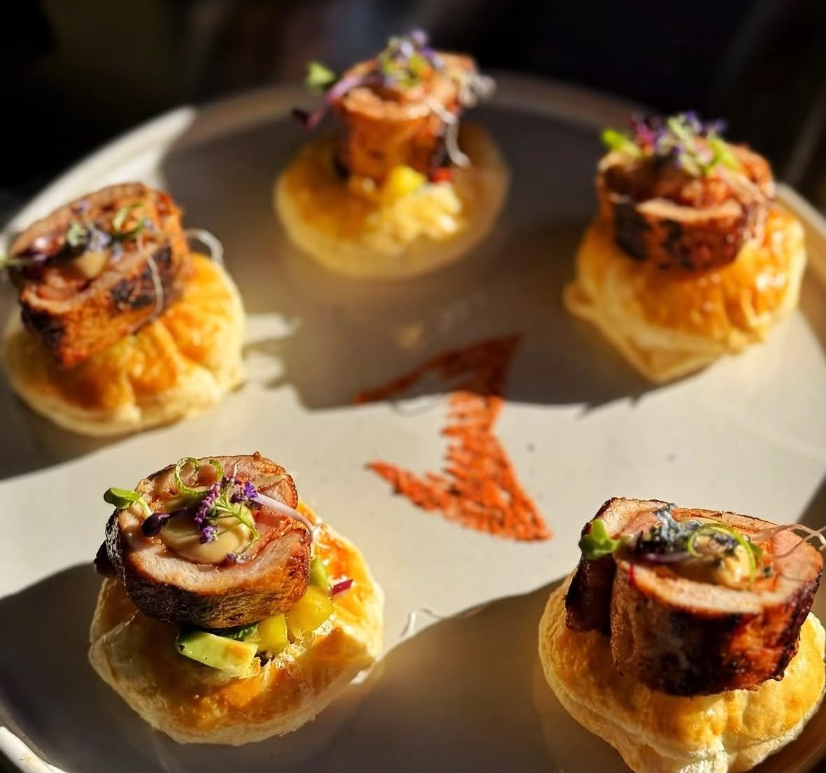 Rolled pork on puff pastry with fresh herbs