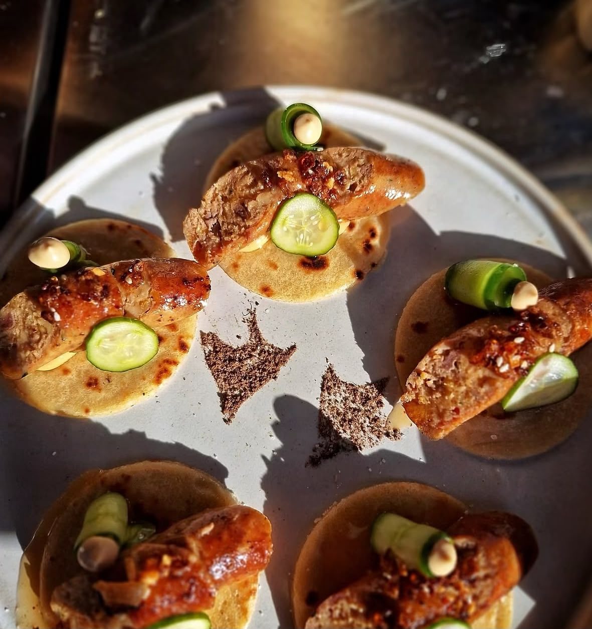 Grilled sausage on a tortilla with cucumber