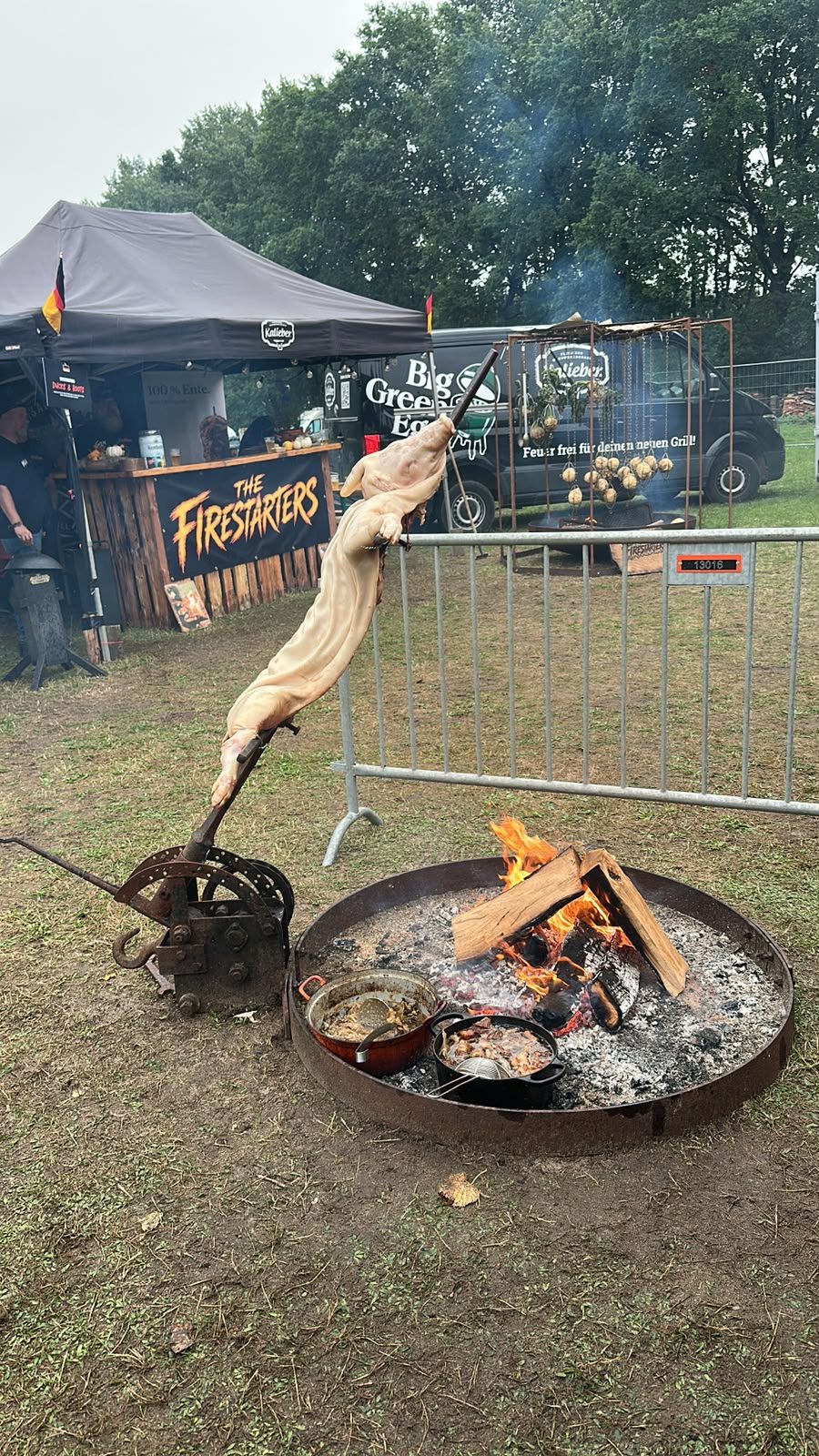 Pig on the cross next to a wood fire